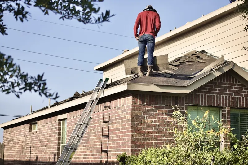 Professional roofer working on a residential roof in Esparto